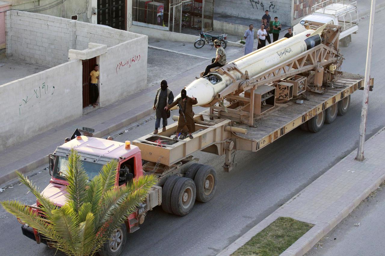 Militant Islamist fighters take part in a military parade along the streets of Syria's northern Raqqa province June 30, 2014. The fighters held the parade to celebrate their declaration of an Islamic 