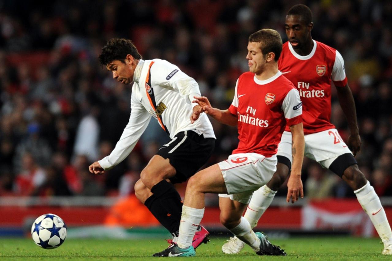 'Shakhtar Donetsk\'s Eduardo (L), and former Arsenal player, vies for the ball against Arsenal\'s midfielder Jack Wilshere (2nd R) during the UEFA Champions League Group H football match at The Emirat