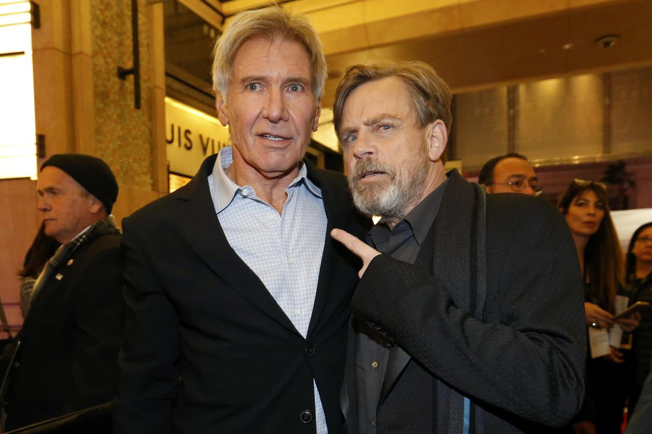 Actors Harrison Ford (L) and Mark Hamill arrive at the premiere of 