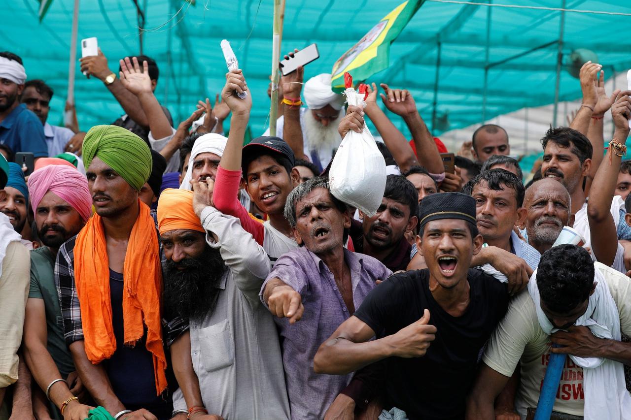 People shout slogans during a Maha Panchayat or grand village council meeting as part of a farmers' protest against farm laws in Muzaffarnagar