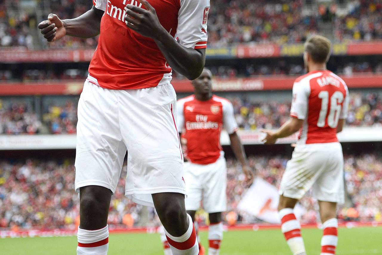 Arsenal's Yaya Sanogo does a dance as he celebrates after scoring against Benfica during their Emirates Cup soccer match at the Emirates stadium in London August 2, 2014.    REUTERS/Dylan Martinez  (BRITAIN - Tags: SPORT SOCCER)