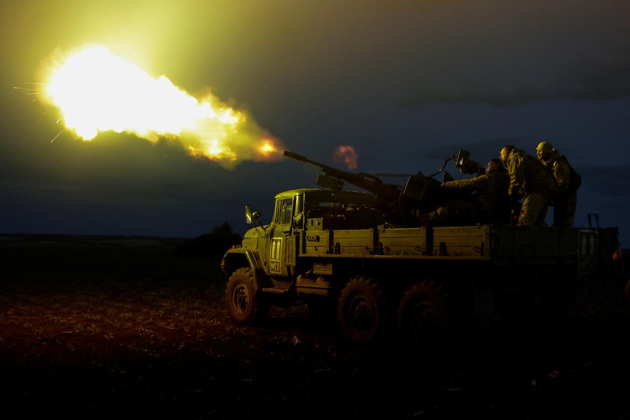 Ukrainian servicemen from mobile air defence unit fire an anti-aircraft cannon towards a Russian drone in Kharkiv region