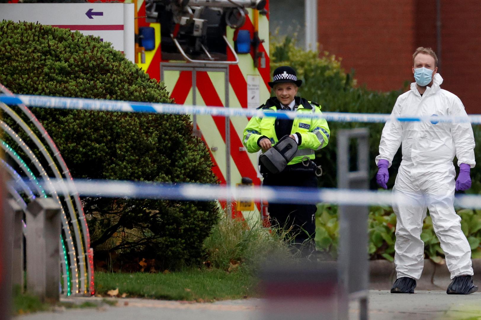 Police, including a forensic officer, stand near the scene of a car blast outside Liverpool Women's Hospital, in Liverpool, Britain, November 15, 2021. REUTERS/Phil Noble