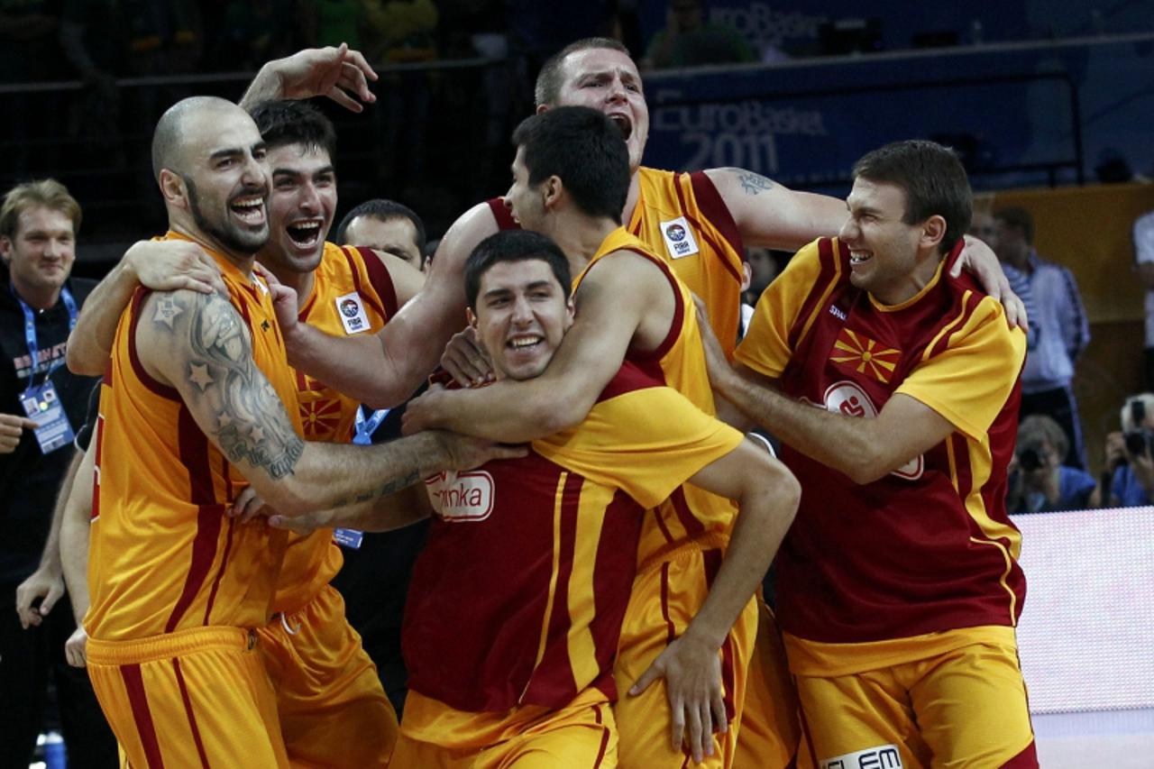 \'Macedonia\'s players celebrate after their FIBA EuroBasket 2011 quarter final basketball game against Lithuania in Kaunas September 14, 2011. REUTERS/Ivan Milutinovic (LITHUANIA  - Tags: SPORT BASKE