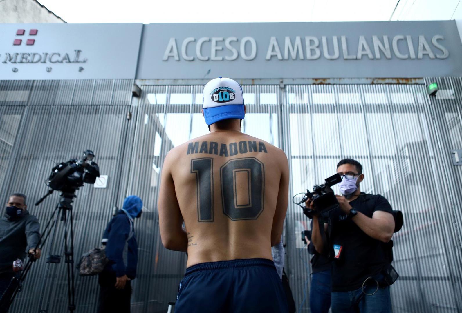 A fan of Argentine soccer great Diego Maradona stands outside the clinic where he will be undergoing surgery for a subdural haematoma, according to his personal physician, in Olivos A fan of Argentine soccer great Diego Maradona stands outside the clinic where he will be undergoing surgery for a subdural haematoma, according to his personal physician, in Olivos, on the outskirts of Buenos Aires, Argentina November 3, 2020. REUTERS/Matias Baglietto MATIAS BAGLIETTO