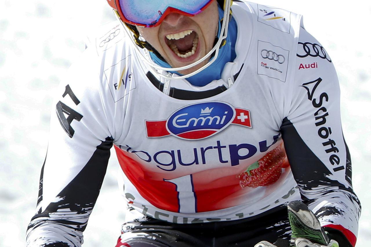 Marcel Hirscher of Austria celebrates winning the season's last race and the slalom World Cup trophy at the FIS Alpine Skiing World Cup Finals in Lenzerheide March 16, 2014.        REUTERS/Leonhard Foeger (SWITZERLAND  - Tags: SPORT SKIING)    Picture Sup