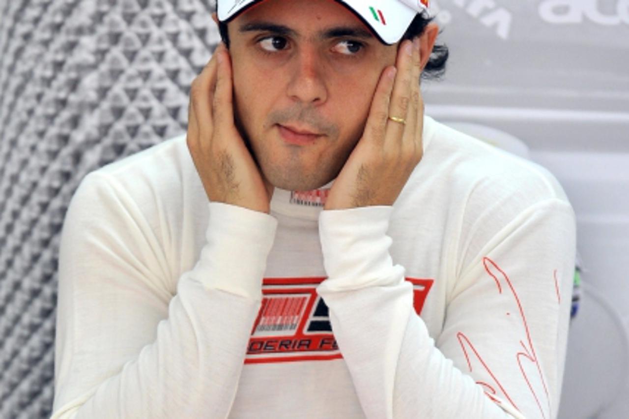 'Ferrari driver Felipe Massa of Brazil stop his ears at the pit during the second practice session at the Korean International Circuit for Formula One\'s Korean Grand Prix in Yeongam on October 22, 20