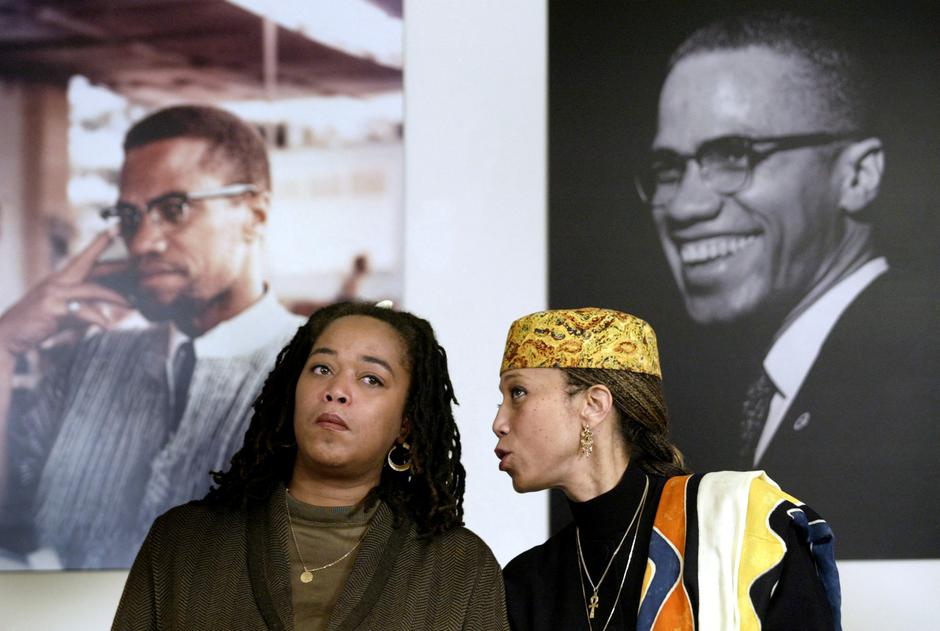 FILE PHOTO: Attallah Shabazz (R) and Malaak Shabazz, two of the six daughters of the late Malcolm X  sit togethe..