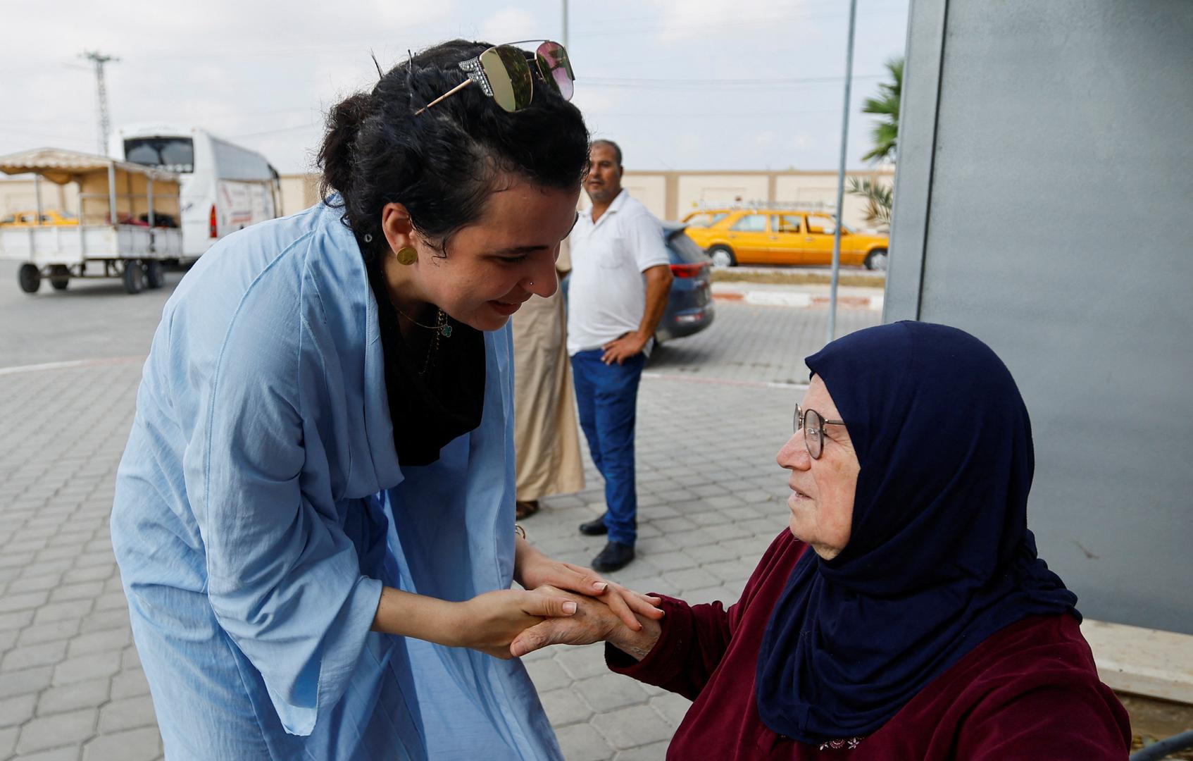 Suzan Besaiso, a Palestinian holding a U.S. passport, holds her grandmother's hand as she waits for permission to leave Gaza, amid the ongoing conflict between Israel and Palestinian Islamist group Hamas, at the Rafah border crossing with Egypt, in Rafah in the southern Gaza Strip, November 2, 2023. REUTERS/Ibraheem Abu Mustafa Photo: IBRAHEEM ABU MUSTAFA/REUTERS
