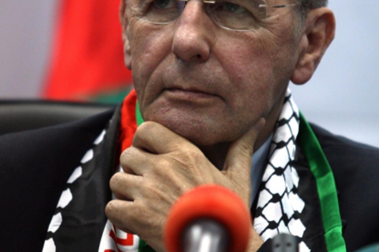 \'International Olympic Committee President Jacques Rogge pauses during a press conference along with Jibril Rajub, the head of the Palestinian Olympic Committee (unseen), in the West Bank city of Ram