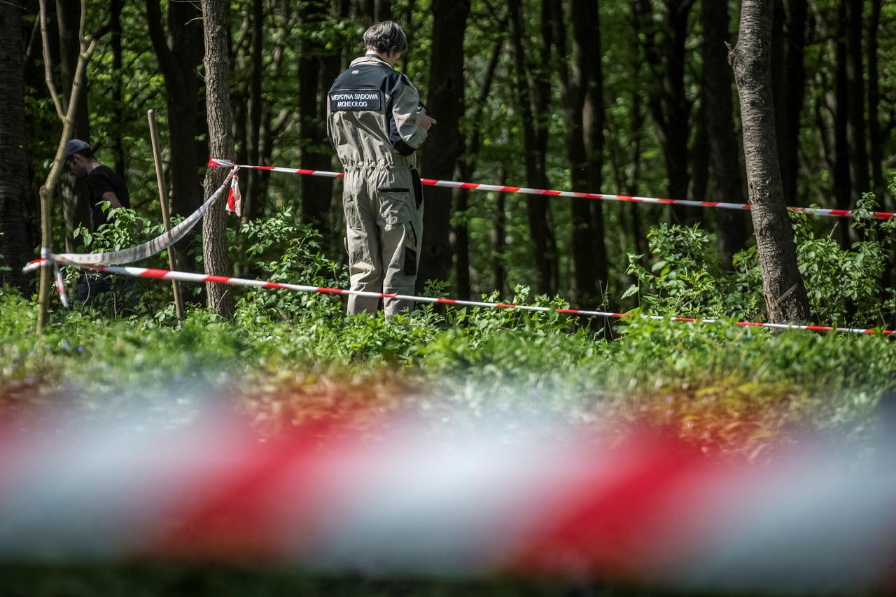 Polish expert works at the burial site of Poles killed by Ukrainian nationalists during World War II before the upcoming exhumation in the former village of Puzhnyky