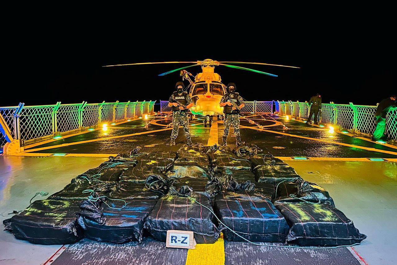 Members of the Mexican Navy stand next to packages following a coastal operation, in which packages were seized with kilograms of presumed cocaine, off the coast of the Mexican Pacific
