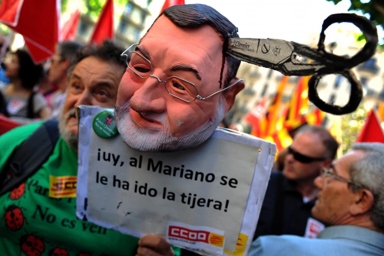 'TOPSHOTS  Members of the two largest Spanish trade unions, UGT and CCOO, protest on May 24, 2012 in Barcelona with an effigy of Prime Minister Mariano Rajoy against a government reform of the labor c