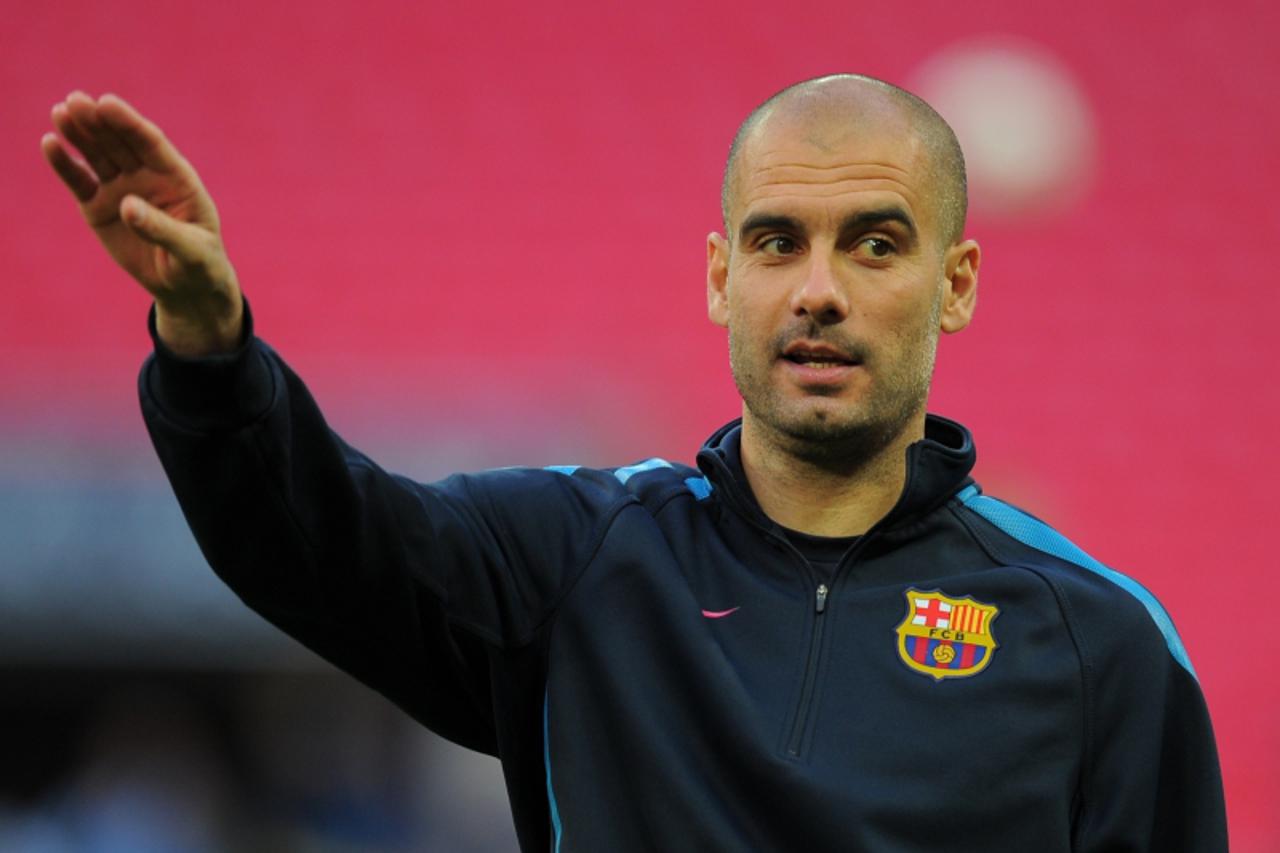 'Barcelona\'s Spanish coach Josep Guardiola gestures during a training session on the eve of the UEFA Champions League final football match FC Barcelona vs. Manchester United, on May 27, 2011 at Wembl