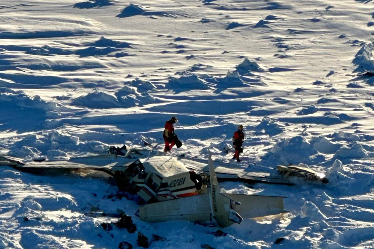 Authorities inspect the wreckage of the Cessna 208B Grand Caravan aircraft operated by Berring Air, near Nome