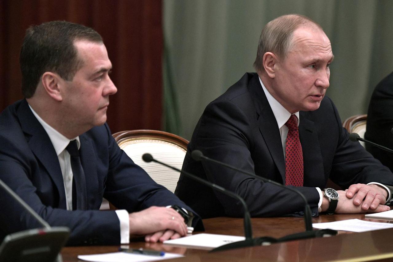 FILE PHOTO: Russian President Putin and Prime Minister Medvedev attend a meeting with members of the government in Moscow