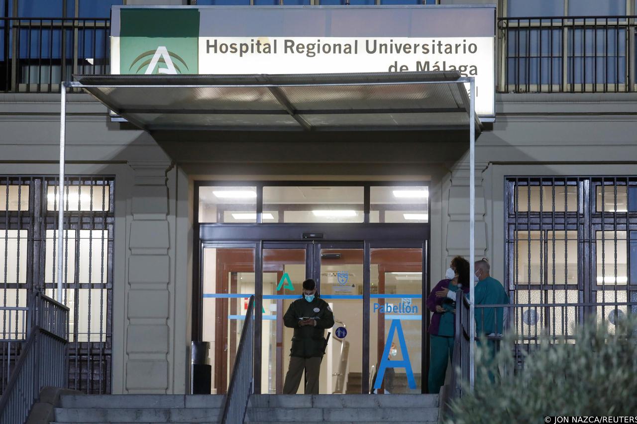 Healthcare workers stand at the front entrance of the Malaga Regional University Hospital