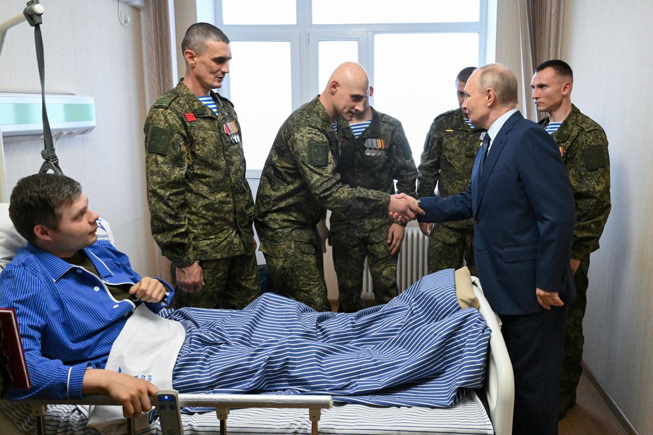 Russian President Vladimir Putin visits a military hospital in Moscow