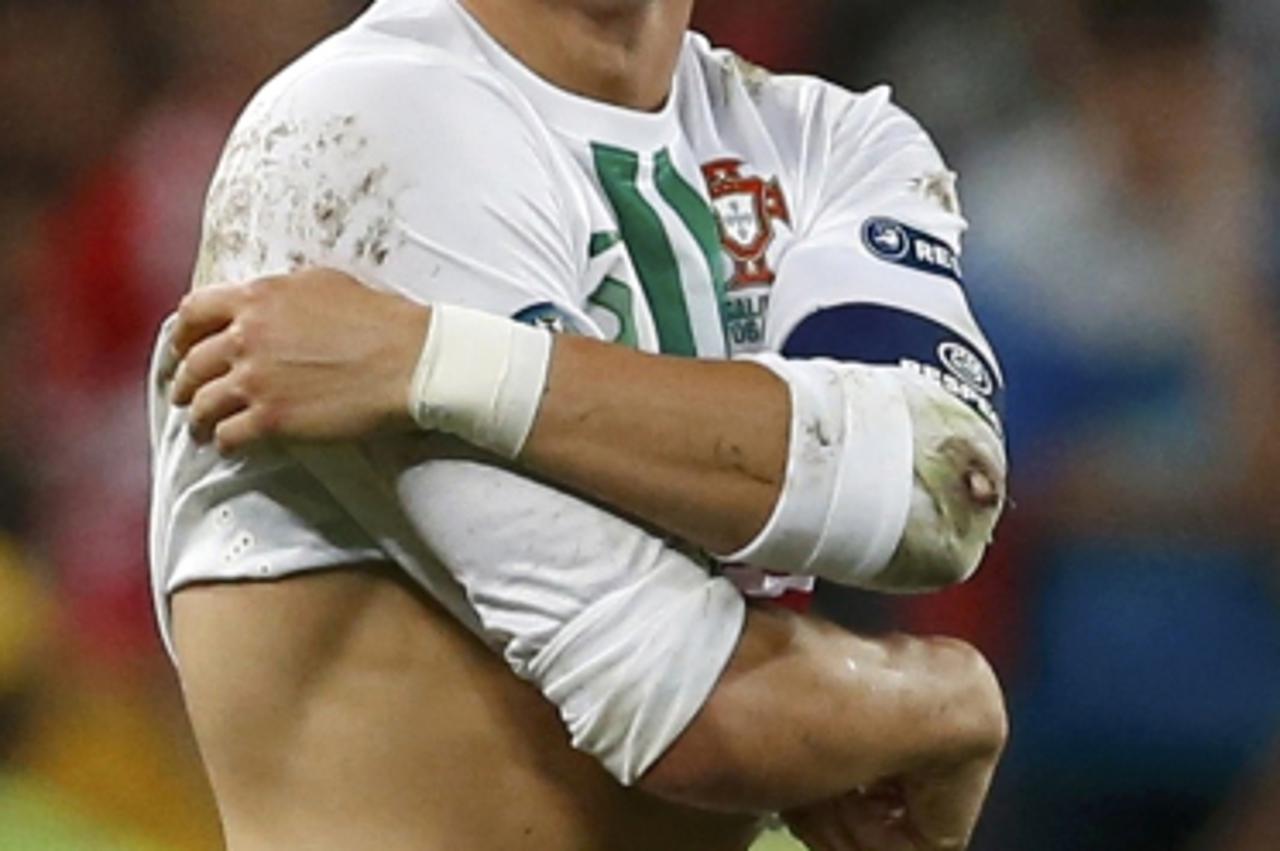'Portugal\'s Cristiano Ronaldo reacts in pain after being fouled during their Euro 2012 semi-final soccer match against Spain at the Donbass Arena in Donetsk, June 27, 2012.   REUTERS/Alessandro Bianc