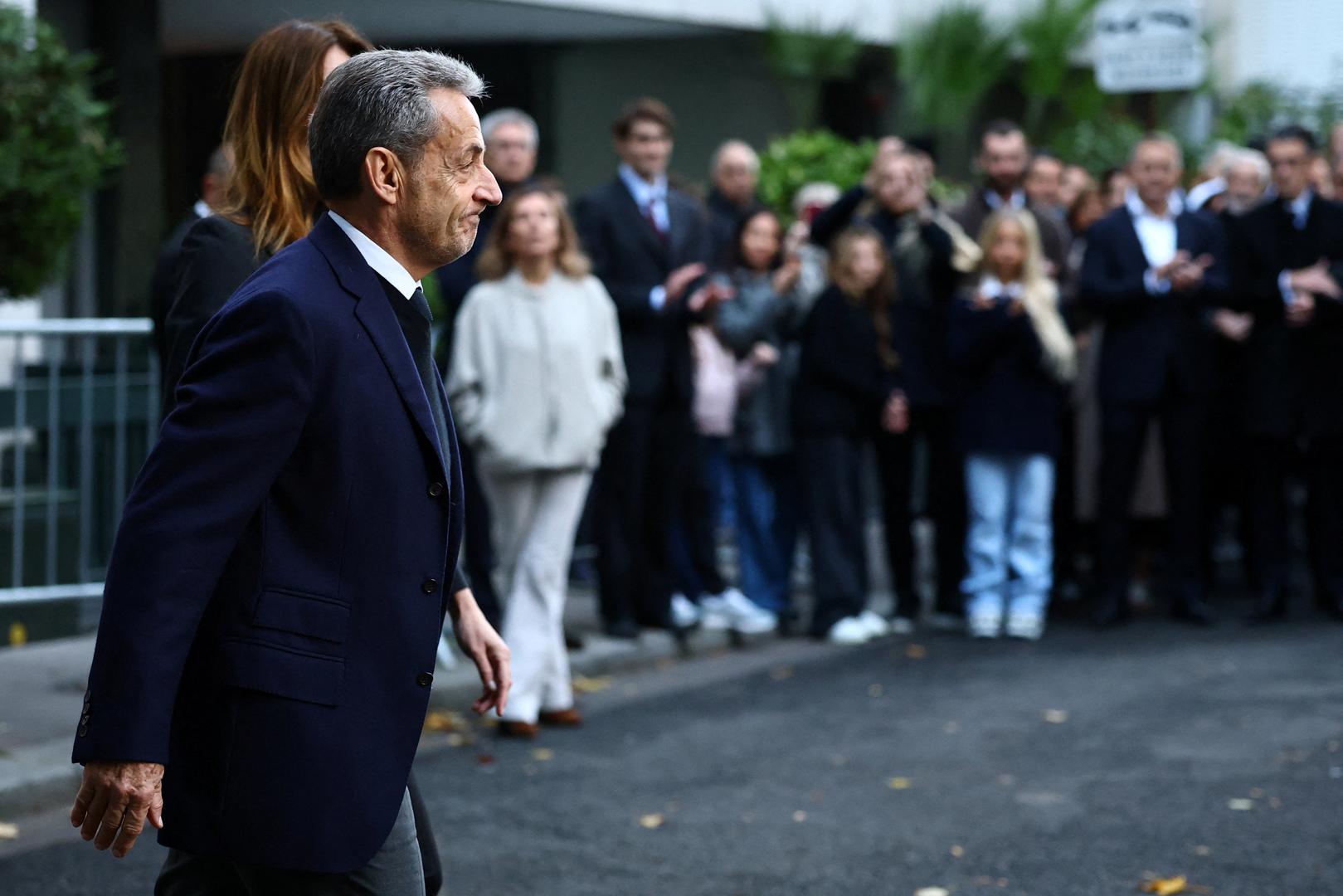 Former French President Nicolas Sarkozy leaves his house with his wife Carla Bruni-Sarkozy on the day of his incarceration at the Sante prison to begin his five-year prison sentence for criminal conspiracy over attempts to raise campaign funds from Libya, in Paris, France, October 21, 2025. REUTERS/Sarah Meyssonnier Photo: Sarah Meyssonnier/REUTERS
