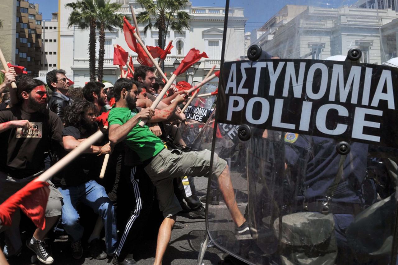 'Demonstrators clash with policemen outside the greek Parliament during a Mayday demonstration on May 1, 2010, in Athens. Greek police fired tear gas on youths as marchers swarmed through central Athe