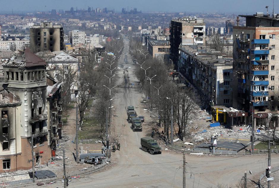 FILE PHOTO: Military vehicles of pro-Russian troops drive along a street in Mariupol