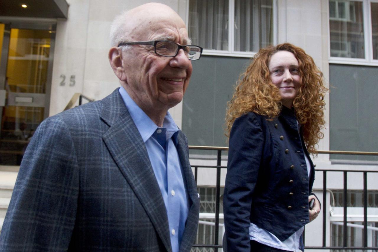 'News Corporation Chief Executive Rupert Murdoch (L) leaves his flat with Rebekah Brooks, chief executive of News International, in central London in this July 10, 2011 file photo. Police have arreste