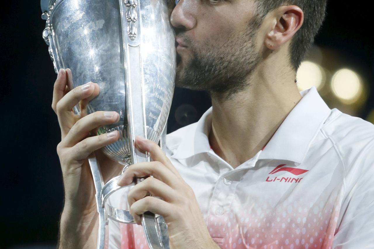 Marin Cilic of Croatia kisses his trophy after defeating Roberto Bautista Agut of Spain in their Kremlin Cup men's single tennis match final in Moscow, Russia, October 25, 2015. REUTERS/Maxim Shemetov