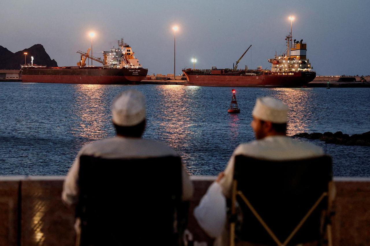 FILE PHOTO: Galaxy Globe bulk carrier and Luojiashan tanker sit anchored in Muscat