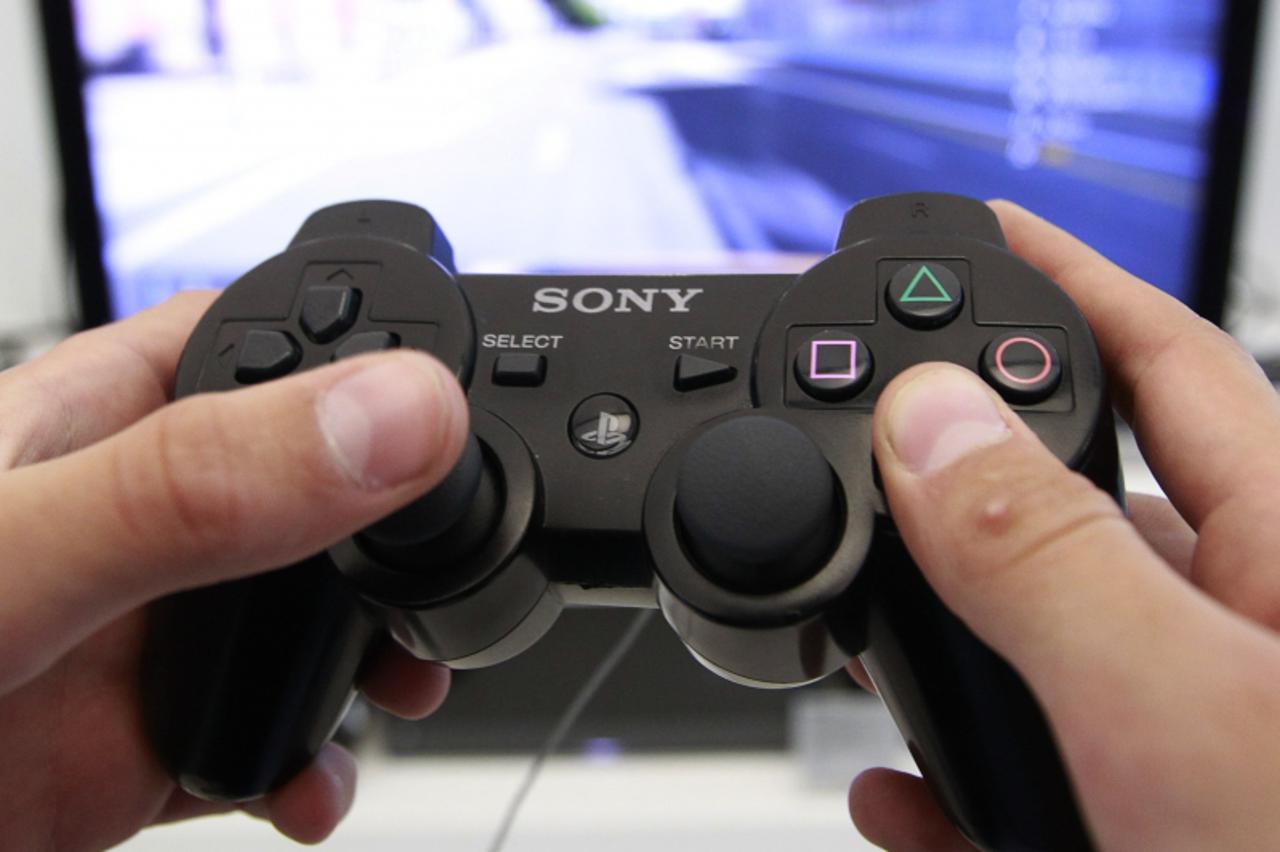 'A person plays a video game at a Sony Playstation in the Sony\'s flagship store in Berlin, April 27, 2011. Sony Corp warned that hackers had stolen names, addresses and possibly credit card details f