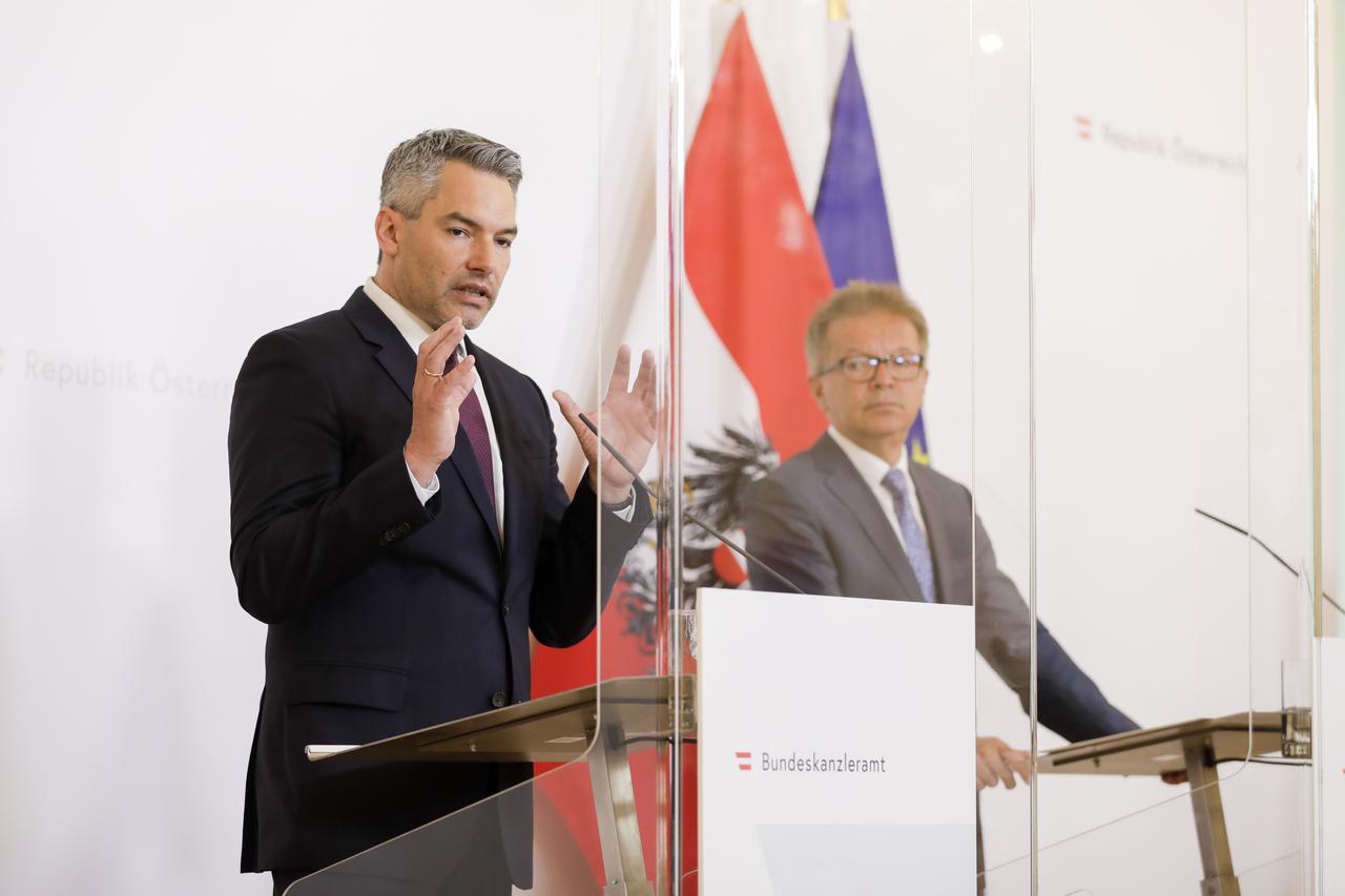 Ministar unutarnjih poslova Nehammer (lijevo) i ministar Anschober (iza stakla)