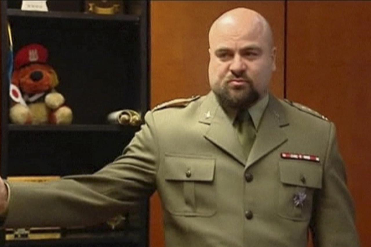 \'A television still image shows Polish military prosecutor Mikolaj Przybyl as he asks media to leave during a news conference in Poznan, January 9, 2012. A Polish military prosecutor shot himself in 