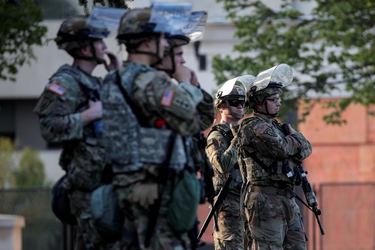 Members of the Wisconsin National Guard stand by as people gather for a vigil, following the police shooting of Jacob Blake, a Black man, in Kenosha, Wisconsin