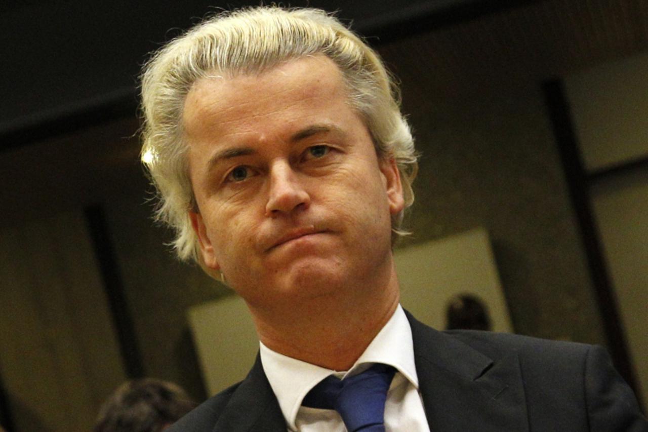 'A file picture shows Dutch anti-Islam deputy Geert Wilders as he sits on October 12, 2010 in court in Amsterdam.  A year ago, Moroccan-born Rahmouna Lakdhari was living an outsider\'s life in her ado