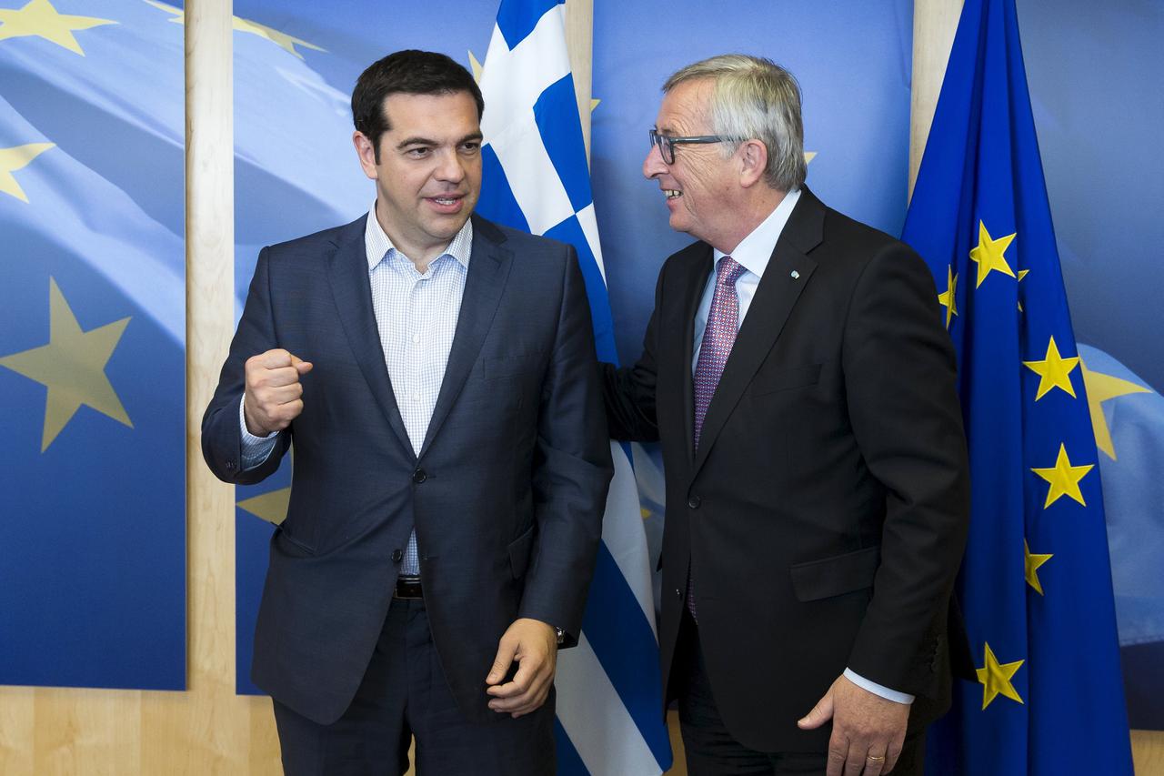 Greek Prime Minister Alexis Tsipras (L) is welcomed by European Commission President Jean-Claude Juncker ahead of a meeting in Brussels, Belgium June 24, 2015. Tsipras flew to Brussels to meet Greece's international creditors on Wednesday to try to bridge