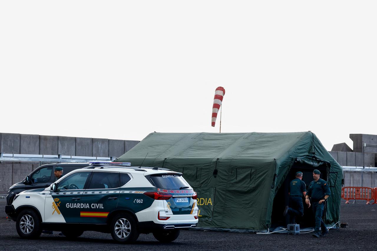 Workers prepare security measures at the port of Granadilla de Abona