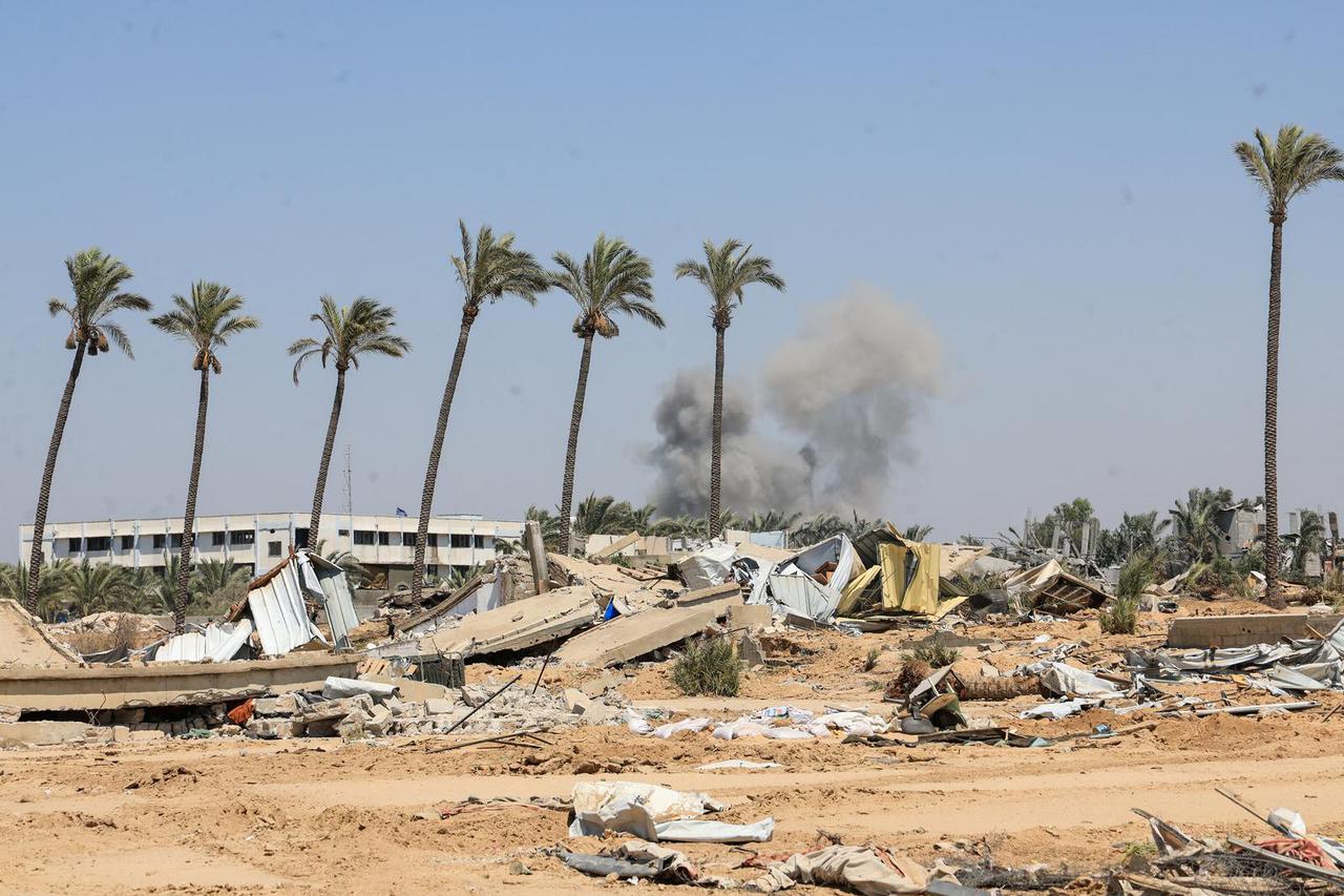 Displaced Palestinians inspect shelters damaged during an Israeli military operation in Deir Al-Balah