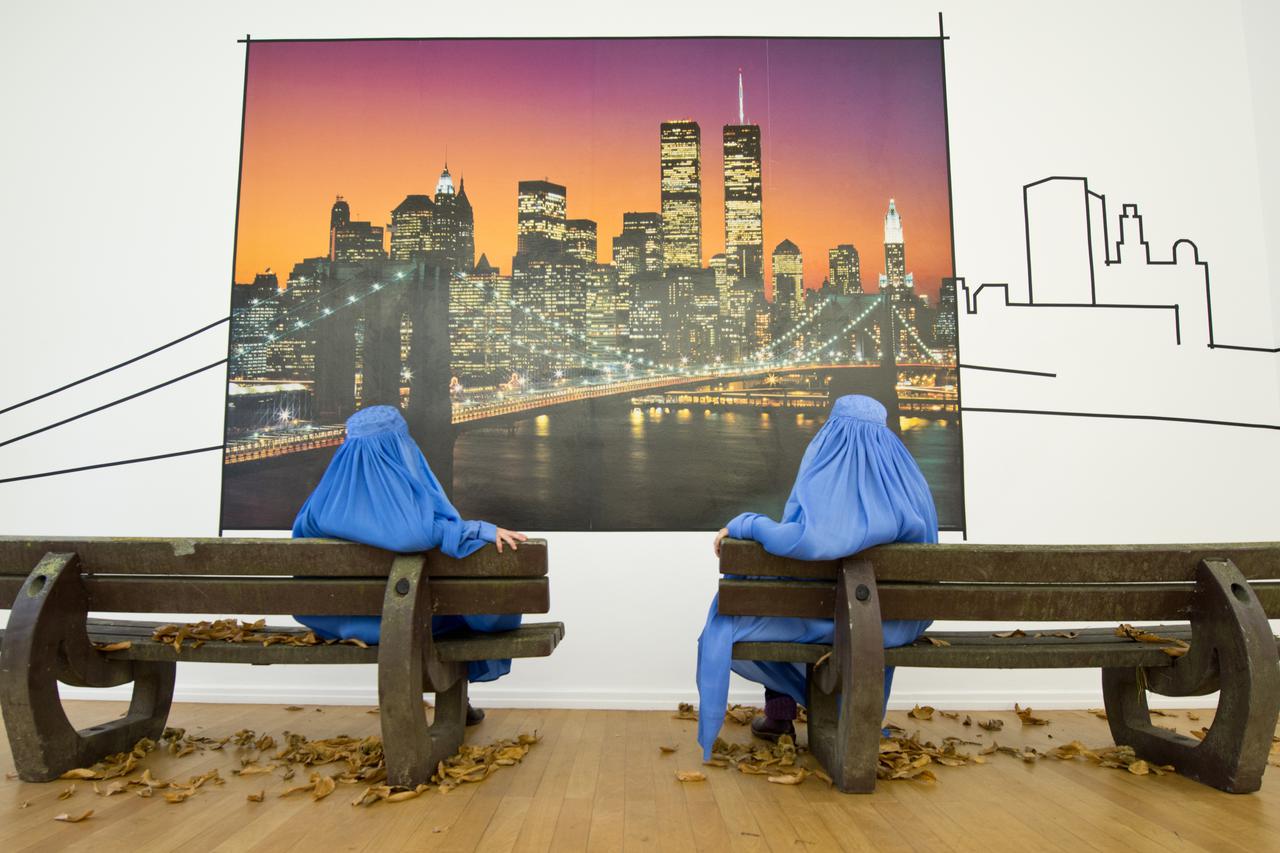 Visitors wear a burqa at the exhibition 'Burquoi'  at the Kunstverein in Wiesbaden, Germany, 22 November 2012. Artist Naneci Yurdagul is concerned with aspects of religious, personal and societal identity in the exhibition. Visitors are sked to wear burqa
