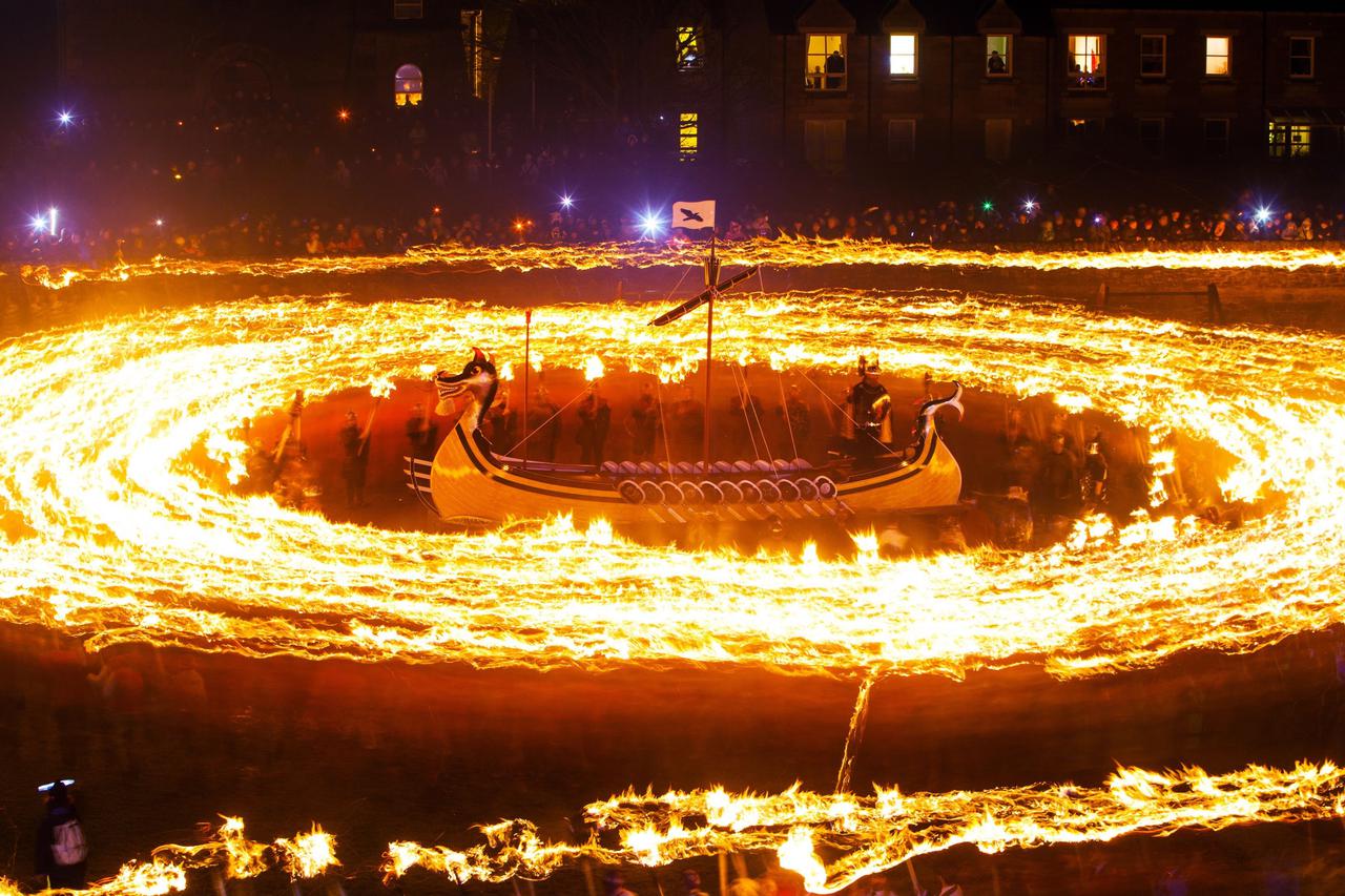 Up Helly Aa Viking festivalMembers of the Jarl Squad dressed in Viking costumes, hold flaming torches as 'guizers' also carrying flaming torches circle an 'Viking longship'' during the Up Helly Aa Viking festival, in Lerwick on the Shetland Isles.Danny La