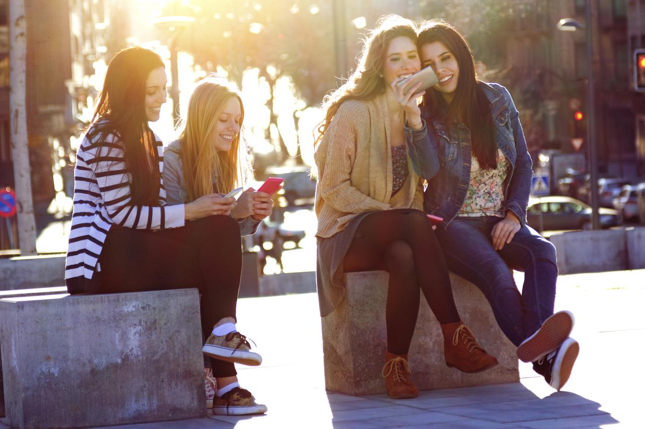 Friends having fun with smartphones