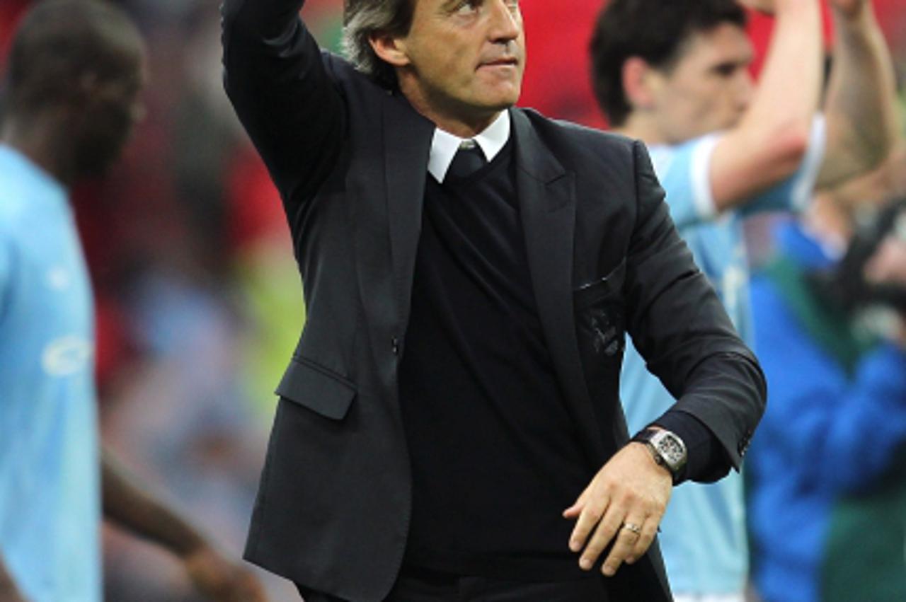 'Manchester City manager Roberto Mancini celebrates after the final whistle Photo: Press Association/Pixsell'