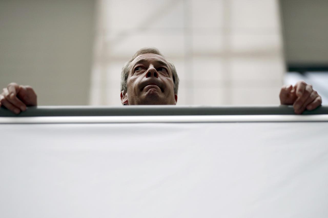 Britain's PM Cameron talks with Greece's PM Tsipras during the EU Summit in BrusselsThe leader of the United Kingdom Independence Party Nigel Farage waits for TV interview during the EU Summit in Brussels, Belgium, June 28, 2016.          REUTERS/Phil Nob