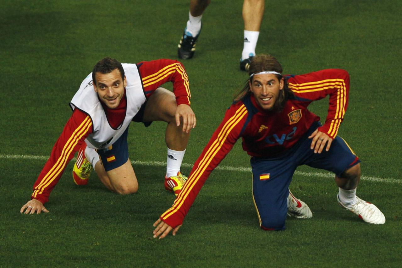 'Spain\'s national soccer team players Roberto Soldado (L) and Sergio Ramos react after fighting for the ball during a training session at La Rosaleda stadium in Malaga February 28, 2012, on the eve o