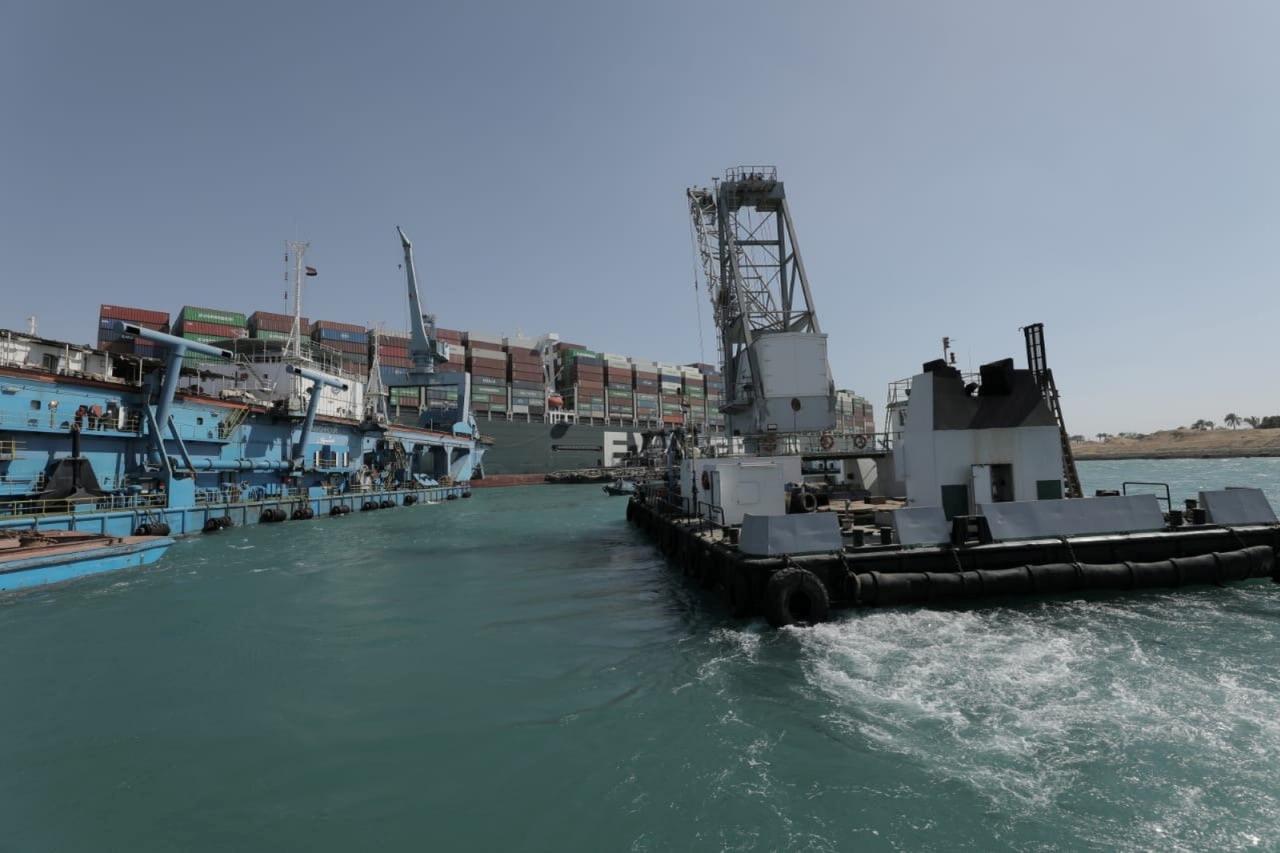 Dredgers attempt to free stranded ship Ever Given, one of the world's largest container ships, in Suez Canal