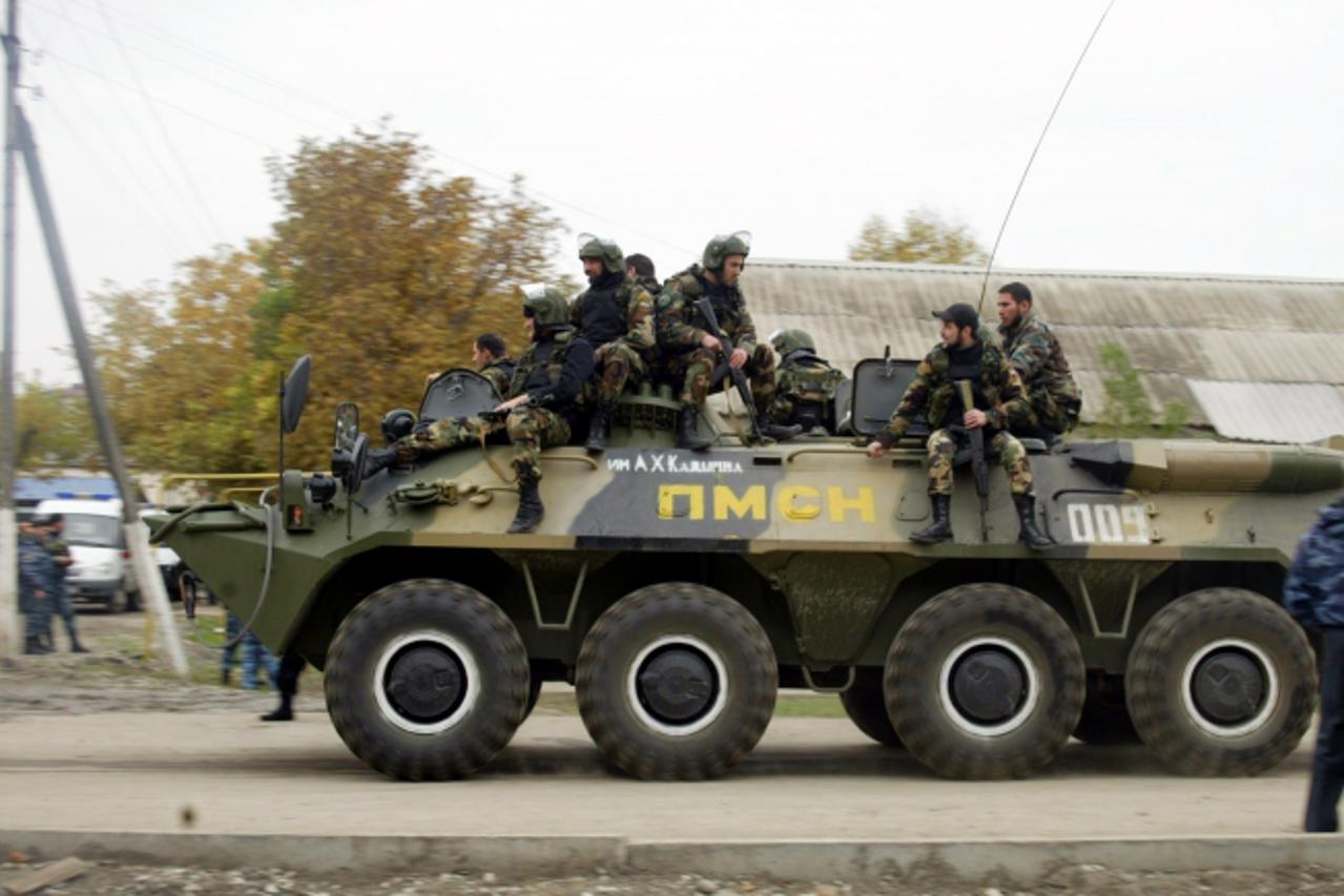 'Chechen special forces ride on a top of an APC near the parliament building in Grozny on October 19, 2010. Militants stormed parliament in Russia\'s conflict-torn Chechnya today, seizing deputies and