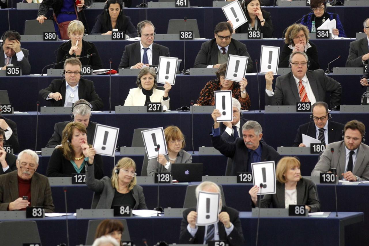 'European deputies hold placards with an exclamation mark to protest against a modification of the Hungarian constitution tending to reinforce the power of the government, at the European Parliament i