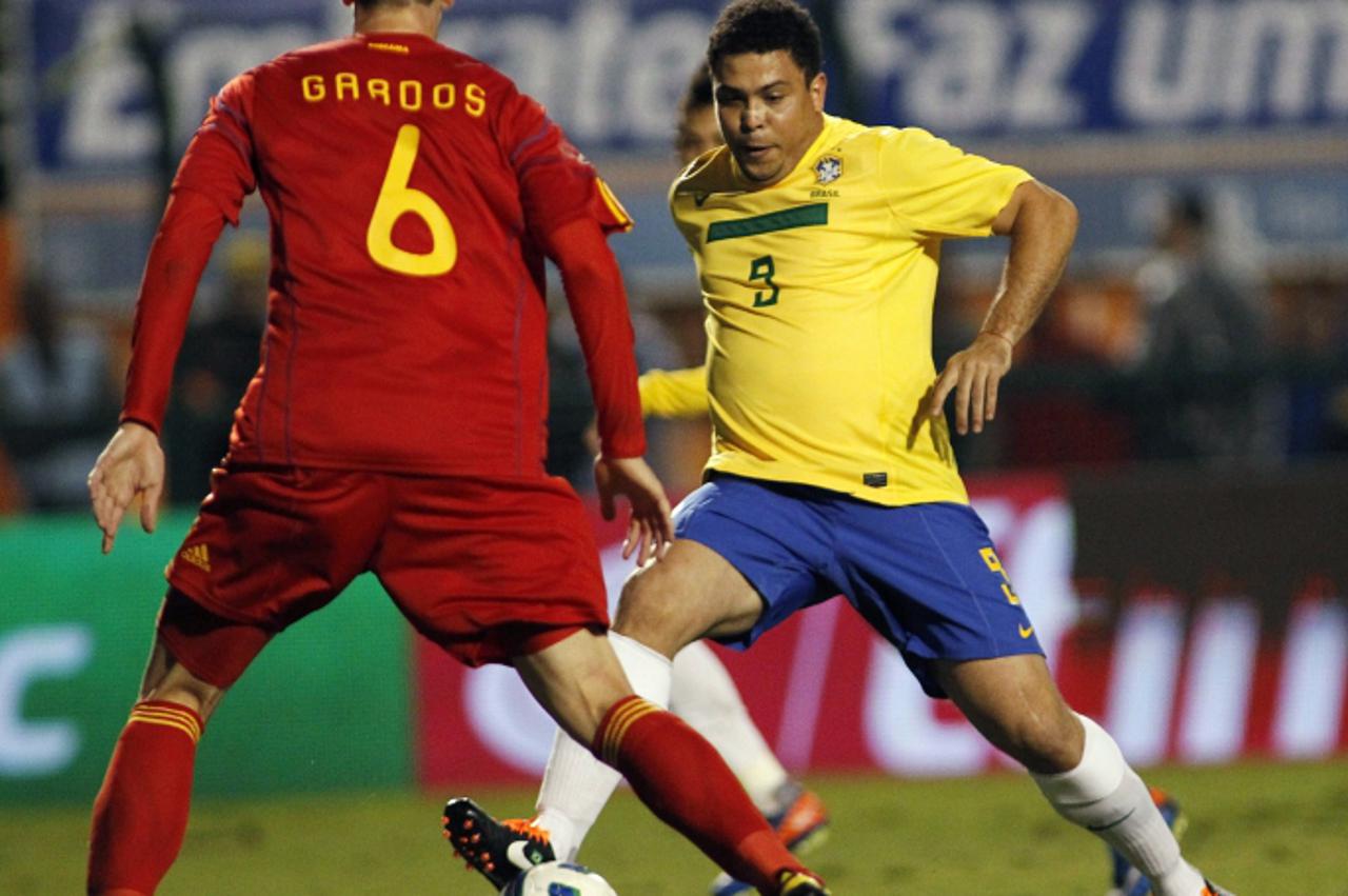 \'Brazilian soccer star Ronaldo (R) vies for the ball with Romania\'s Florin Gardos during a friendly football match, at Pacaembu stadium, in Sao Paulo, Brazil, on June07, 2011. Ronaldo played against