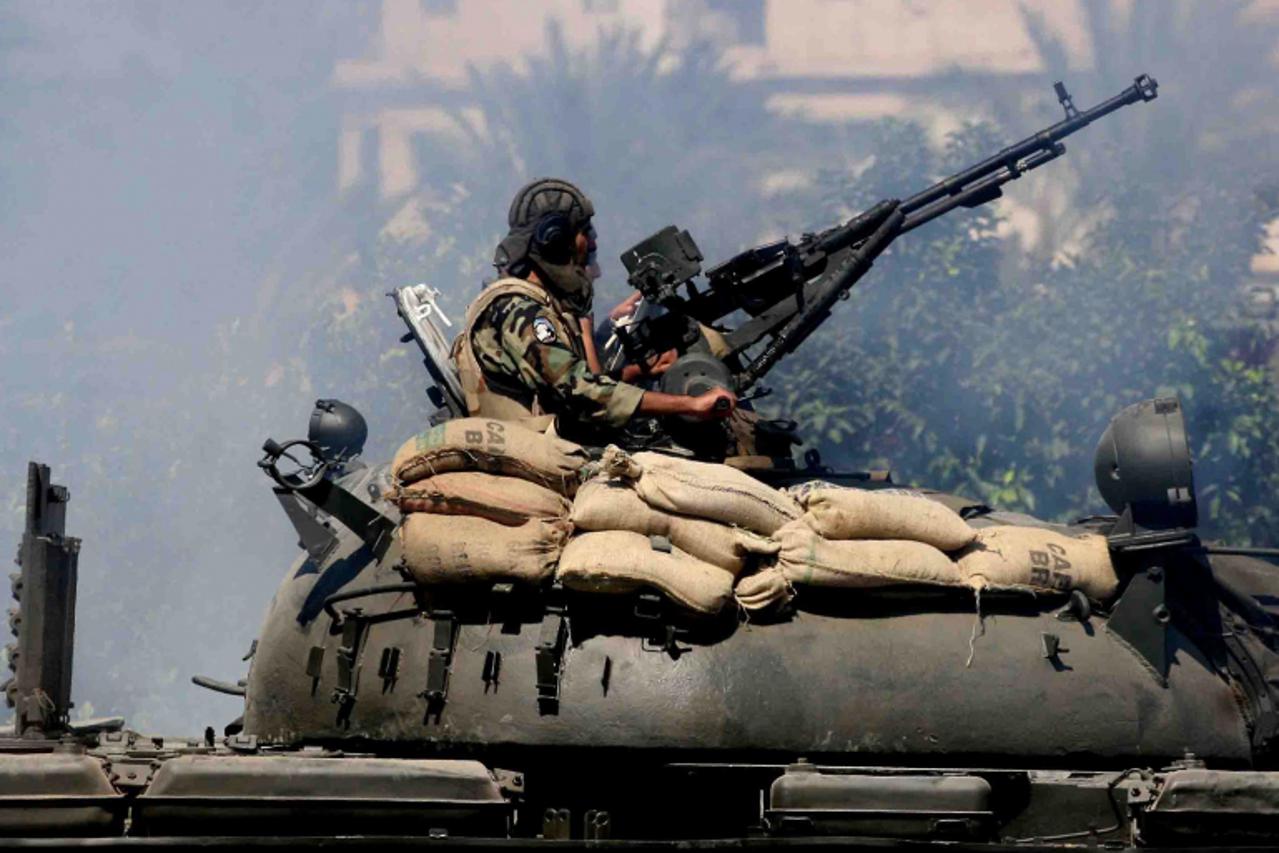 'Lebanese security forces sit atop a tank as they take position in the northern city of Tripoli following clashes between pro- and anti-Syrian regime supporters on August 21, 2012. Clashes erupted day