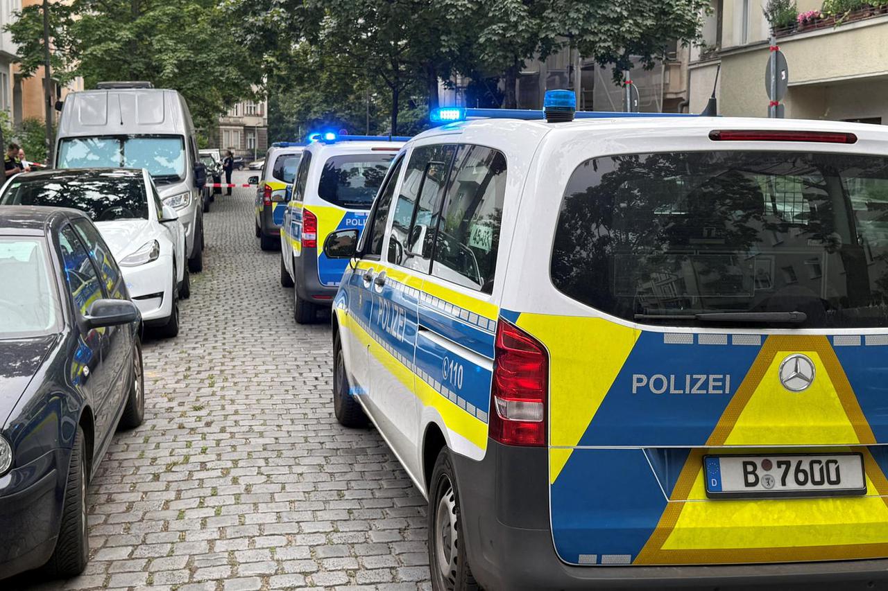 Police cars a line up inside a perimeter secured by police at the scene of a shooting in Berlin