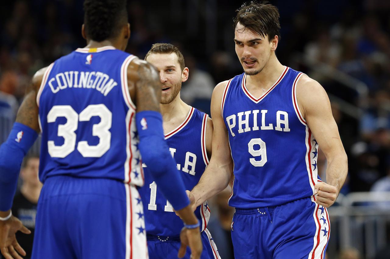 NBA: Philadelphia 76ers at Orlando Magic Feb 9, 2017; Orlando, FL, USA; Philadelphia 76ers forward Dario Saric (9) celibates with guard Nik Stauskas (11) and forward Robert Covington (33) after he made a shot in the fourth quarter against the Orlando Magi